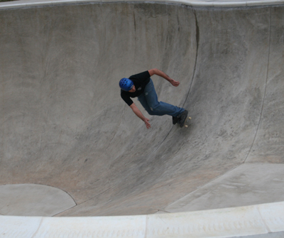 Person skating down a deep basin