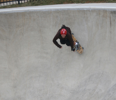 Different person skating down a deep basin